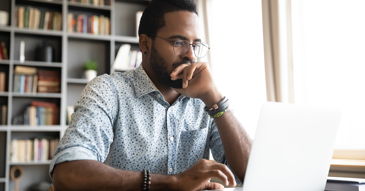 man, glasses, watch, button down, book shelf, laptop, bright, scared, timid, research