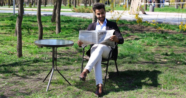 Guy Reading Print Newspaper Must Be Steampunk or Something