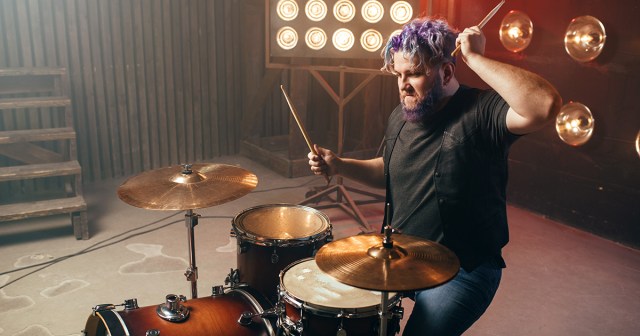Fatso Leaves Shirt on While Drumming