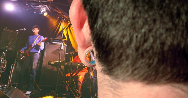 Man Watches Entire Show Through The Gauged Ear Of Guy In Front Of Him