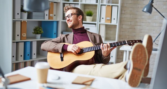Cool Boss with Guitar in Office Totally Chill about Rampant Sexual Harassment