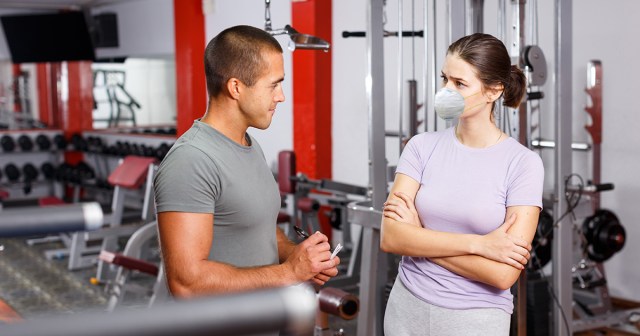 Confused Guy Instinctively Motions for Woman at Gym to Remove N95 Mask Before Talking at Her