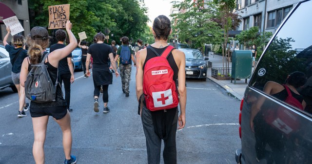 Volunteer Medic Applying Bandage to Injury Closest Thing Protester Had to Health Care in Years