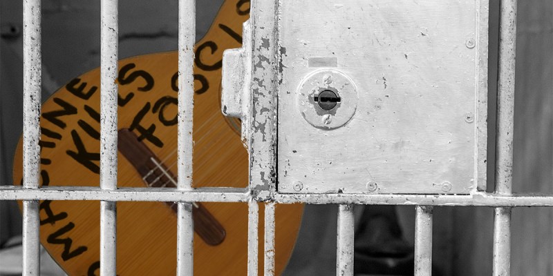 guthrie, woody, guitar, fascist, jail