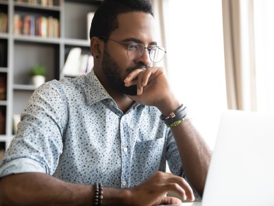 man, glasses, watch, button down, book shelf, laptop, bright, scared, timid, research