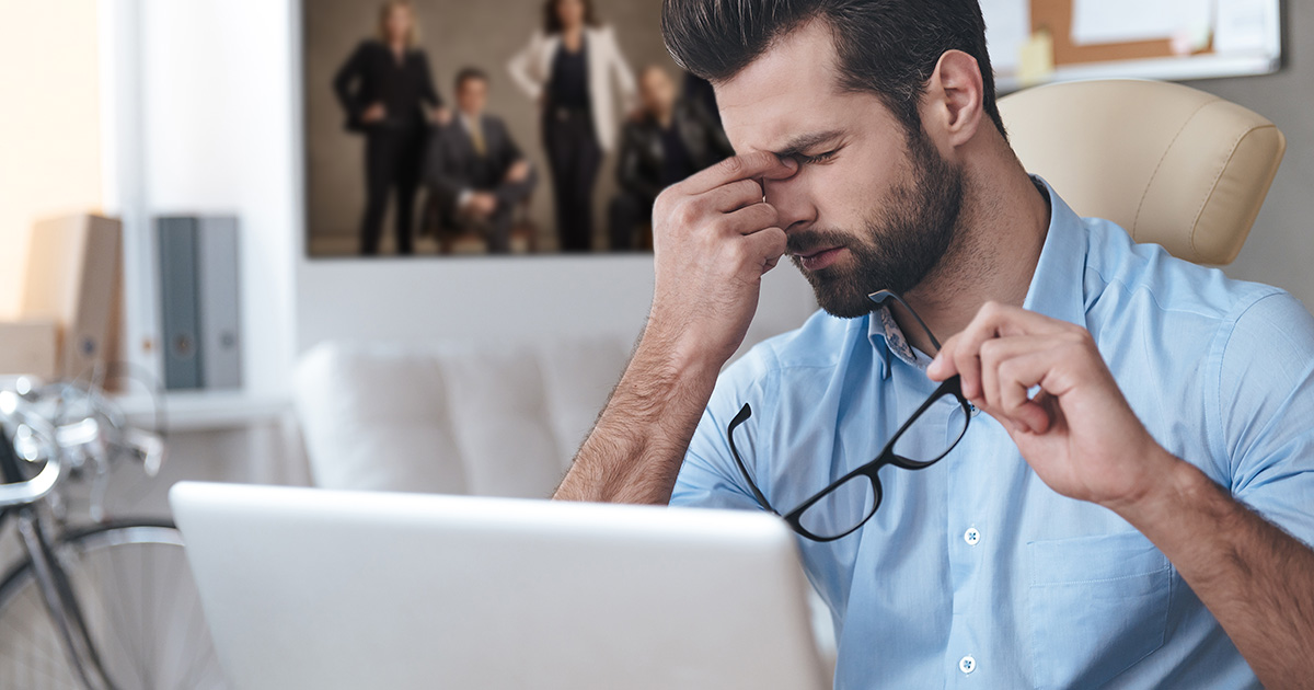 gross, heinous, glasses, beard, computer, button down, blue shirt, white couch, frustrated