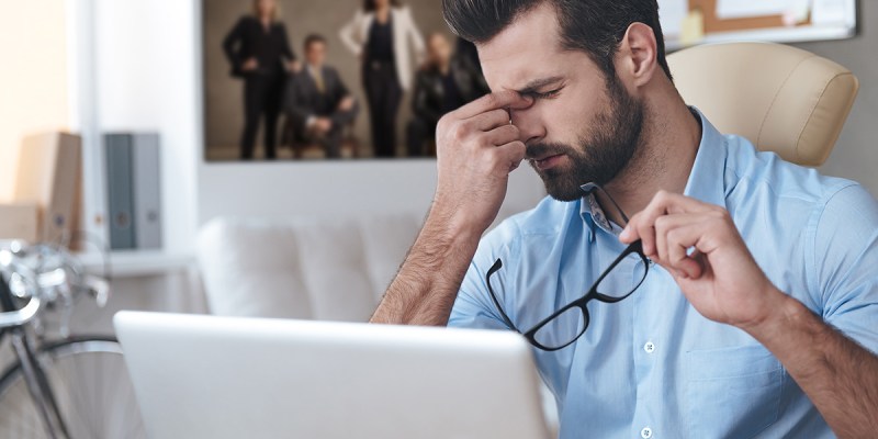 gross, heinous, glasses, beard, computer, button down, blue shirt, white couch, frustrated