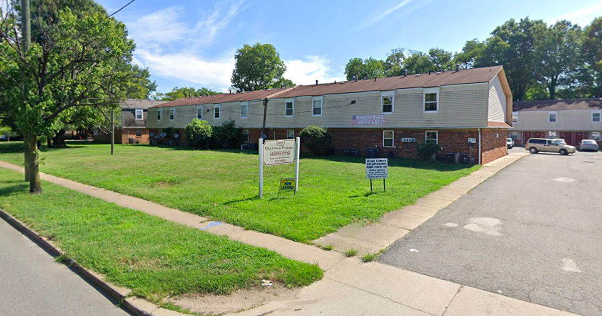 crappy, estate, grass, green, nice, red roof, sign, building, sidewalk, apartment