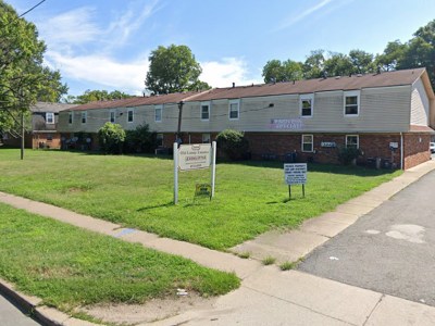 crappy, estate, grass, green, nice, red roof, sign, building, sidewalk, apartment