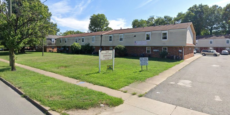 crappy, estate, grass, green, nice, red roof, sign, building, sidewalk, apartment