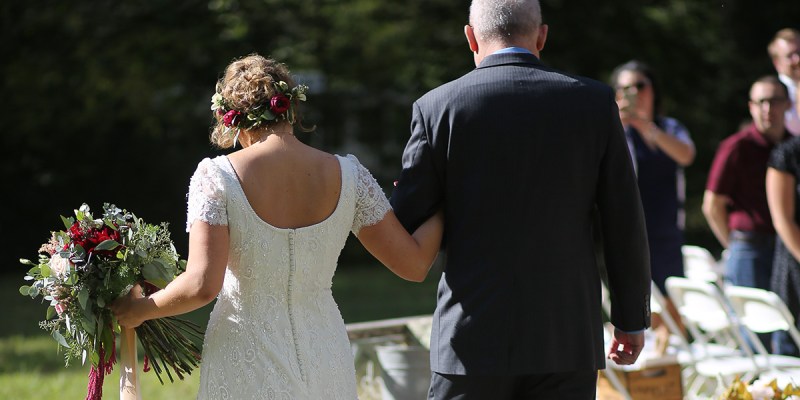 dress, white, open back, flowers, father, aisle, walk, sunny, outside, skin tone, light, white, blonde, suit, tie, fancy