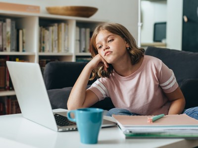 girl, cup, drink, blue, bored, computer, game, young, pink shirt, shelf, book case, macbook, chess, play, slouch