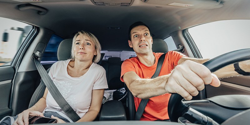 orange shirt, white shirt, man, drive, woman, passenger, scared, white knuckle, anxious, stressed, annoying, confusing, upsetting, crappy car, poor, beater, music, list, ice, ice breaker, funny, sad