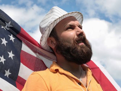 man, beard, fedora, blue sky, america, american flag, wind, billow, heroic, bold, intrusive, pirate, this land is your land, steal, vote, politician, president, politics, dumb, ignorant