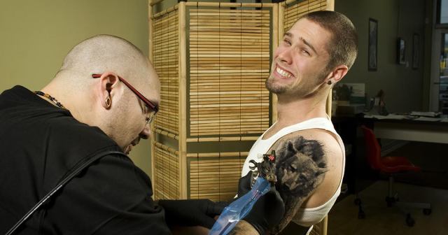 Man Turns Lifelong Passion For Wolves Into Shitty Bicep Tattoo