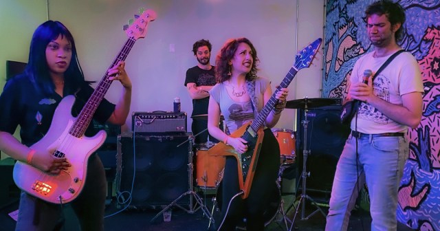 Singer Pressured to Improve Stage Banter After Bassist Learns “Seinfeld” Theme