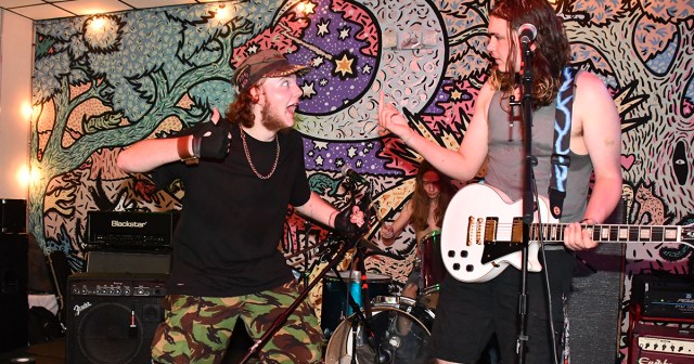 Man in Audience Way Too Proud After Picking Up Singer’s Knocked Over Mic Stand