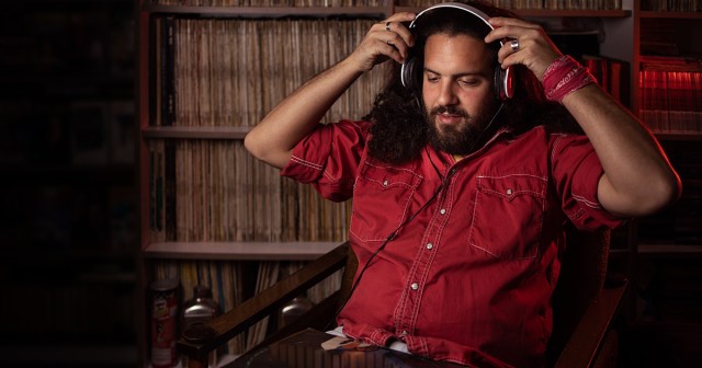 Man Building Up Courage to Listen to Favorite Band’s Recent Stuff