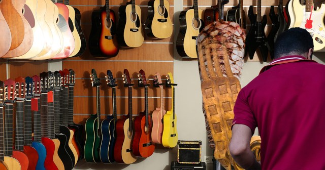 Guitar Center Employee Cuts Fresh Strap From Rotating Spit