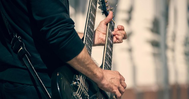 Man Playing Double-Neck Guitar Clearly Overcompensating for Having Only One Penis