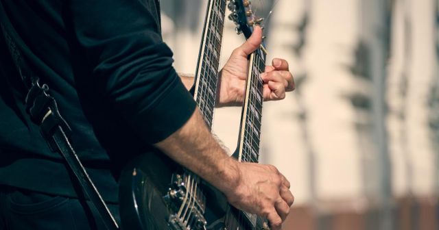 Man Playing Double-Neck Guitar Clearly Overcompensating for Having Only One Penis