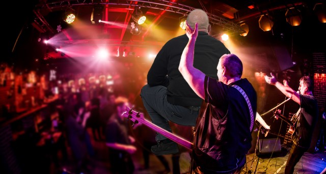 Singer Lifts Replacement Drummer by Scruff of Neck to Introduce Him to Crowd Like Newborn Puppy