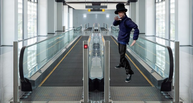 Guy From Jamiroquai Taking Up Entire Moving Walkway at Airport