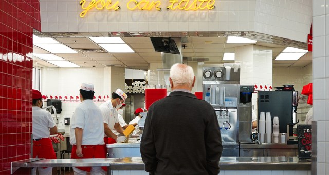 Boomer Stands at Pickup Counter and Watches Fast Food Employees Prepare His Meal With the Focus of a Stalking Leopard