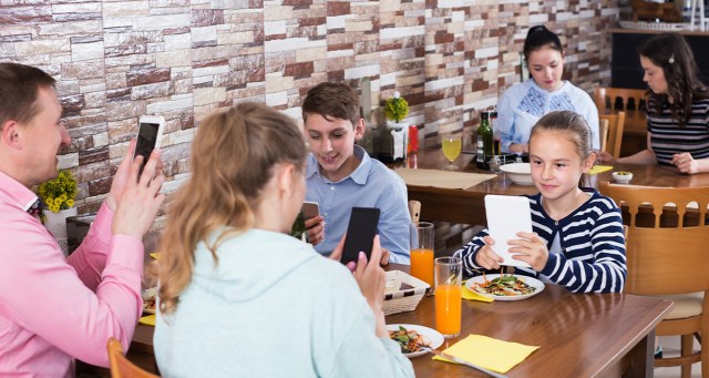 Nation’s Families Announce Plans to Sit Next to You at Restaurant While All Looking at Devices at Full Volume