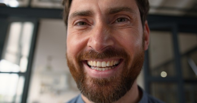 Impossible To Tell if Man Genuinely Cheerful or Burying Some Really Heavy Shit